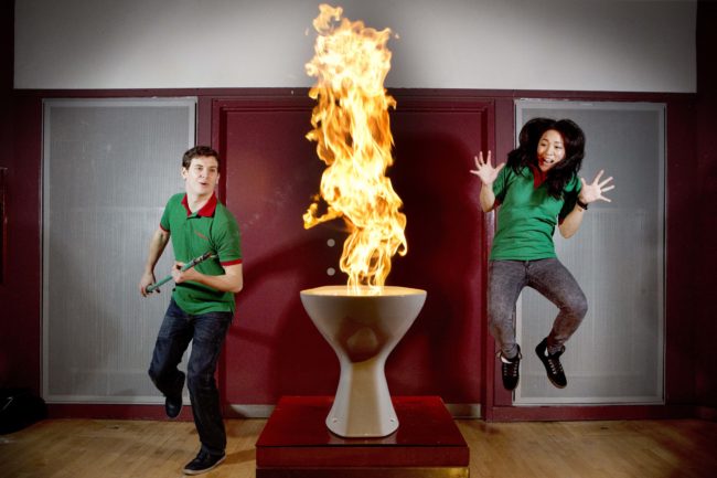 16.12.13Techniquest science demonstrations A shocked girl jumping and staring boy looking at a fire