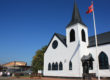 External view of Norwegian Church with Wales Millennium Centre in the distance