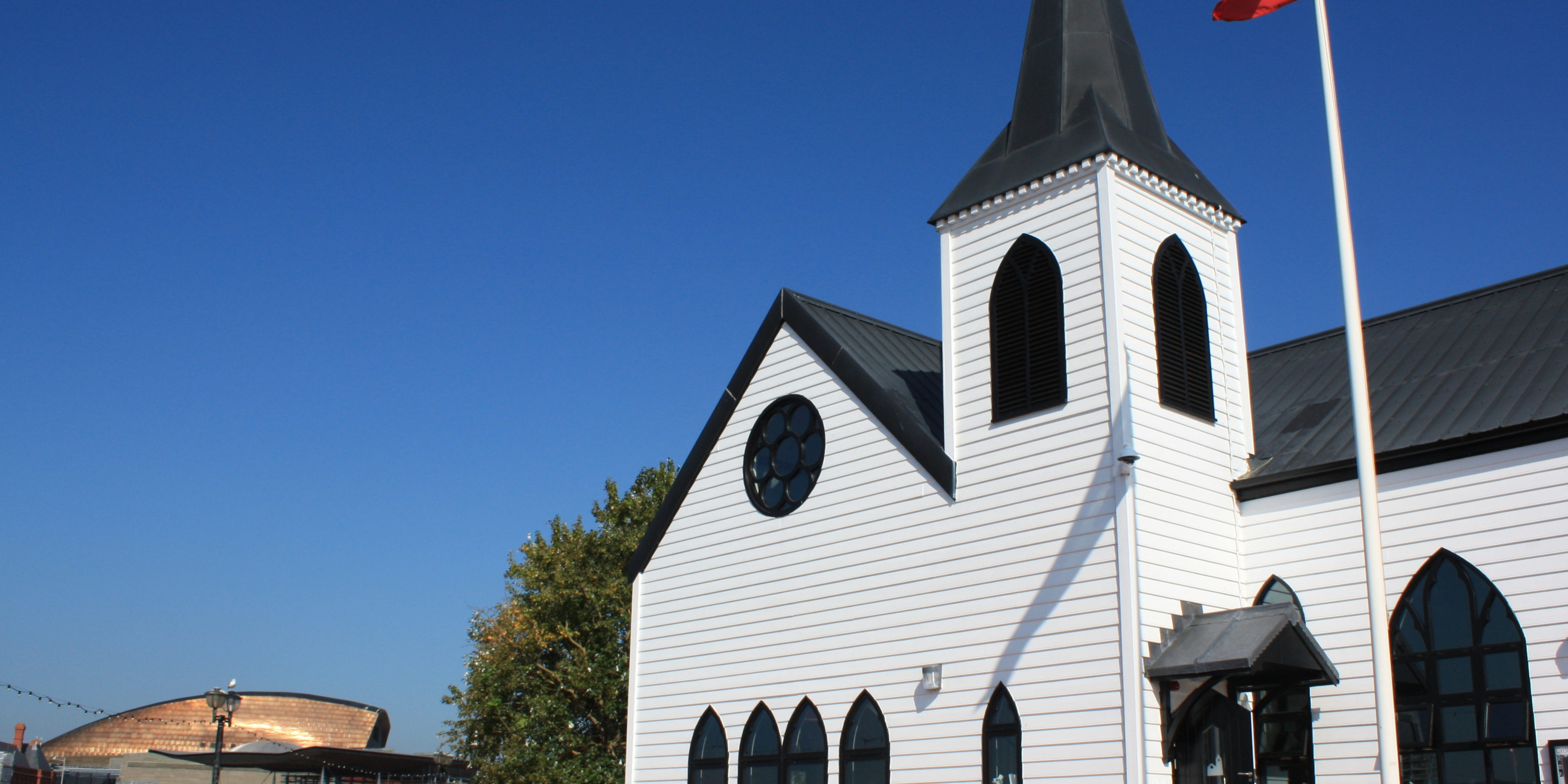 External view of Norwegian Church with Wales Millennium Centre in the distance