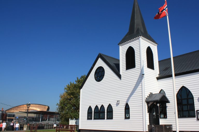 External view of Norwegian Church with Wales Millennium Centre in the distance