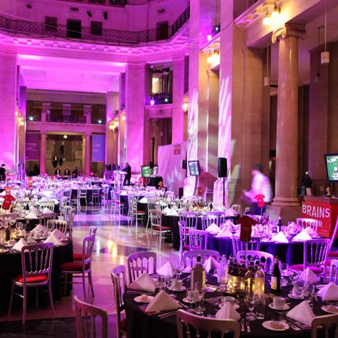 Round tables set up for a dinner inside the museum