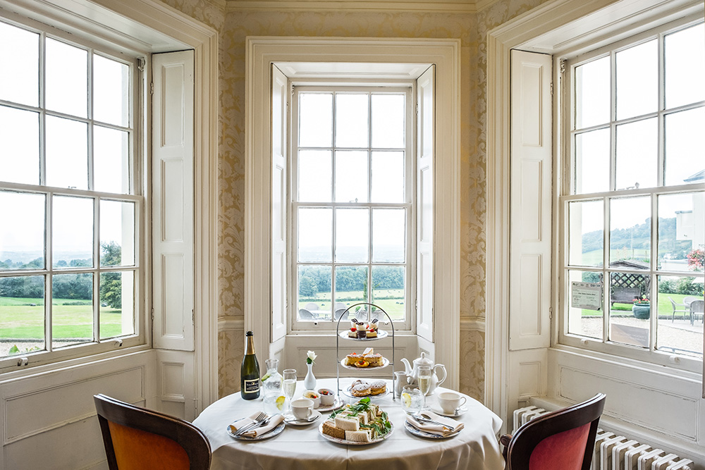 Table set for afternoon tea in an elegant bay window
