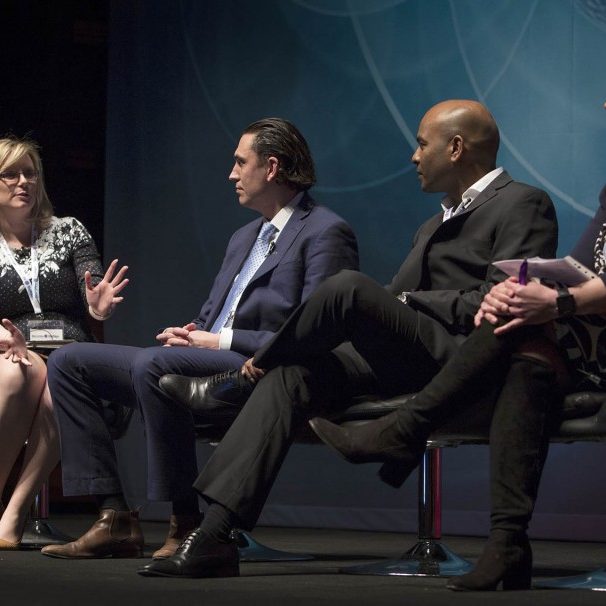 Conference taking place with speakers and guests on stage