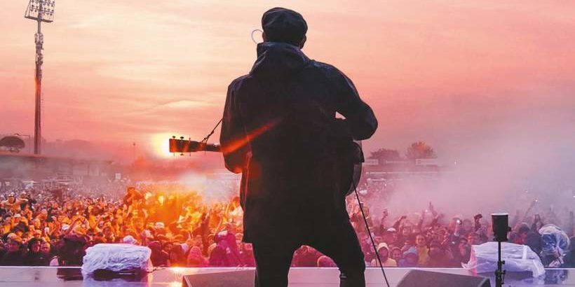 gerry_cinnamon-5750256377 Gerry Cinnamon from the back on stage in front of a crowd in the evening